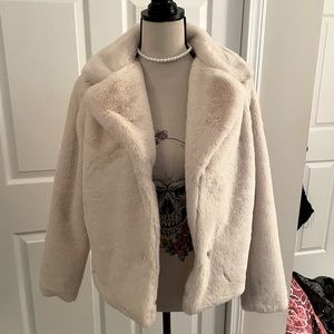 Fergie: Cream faux fur coat